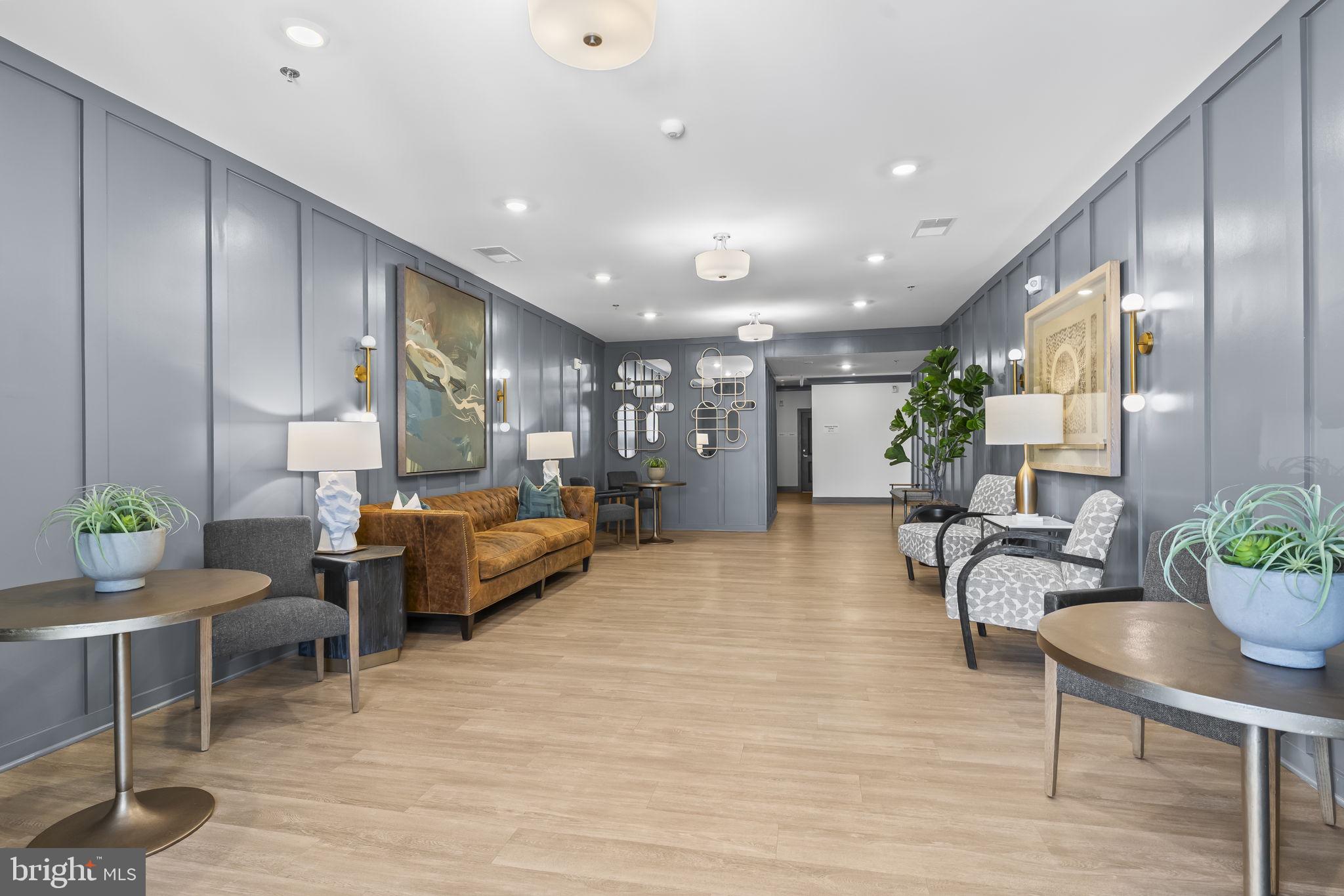 4007 Seaside Alder Road, Unit 8307 Bowie, MD 20720 - Photo 2 of 32 a living room with furniture and a potted plant