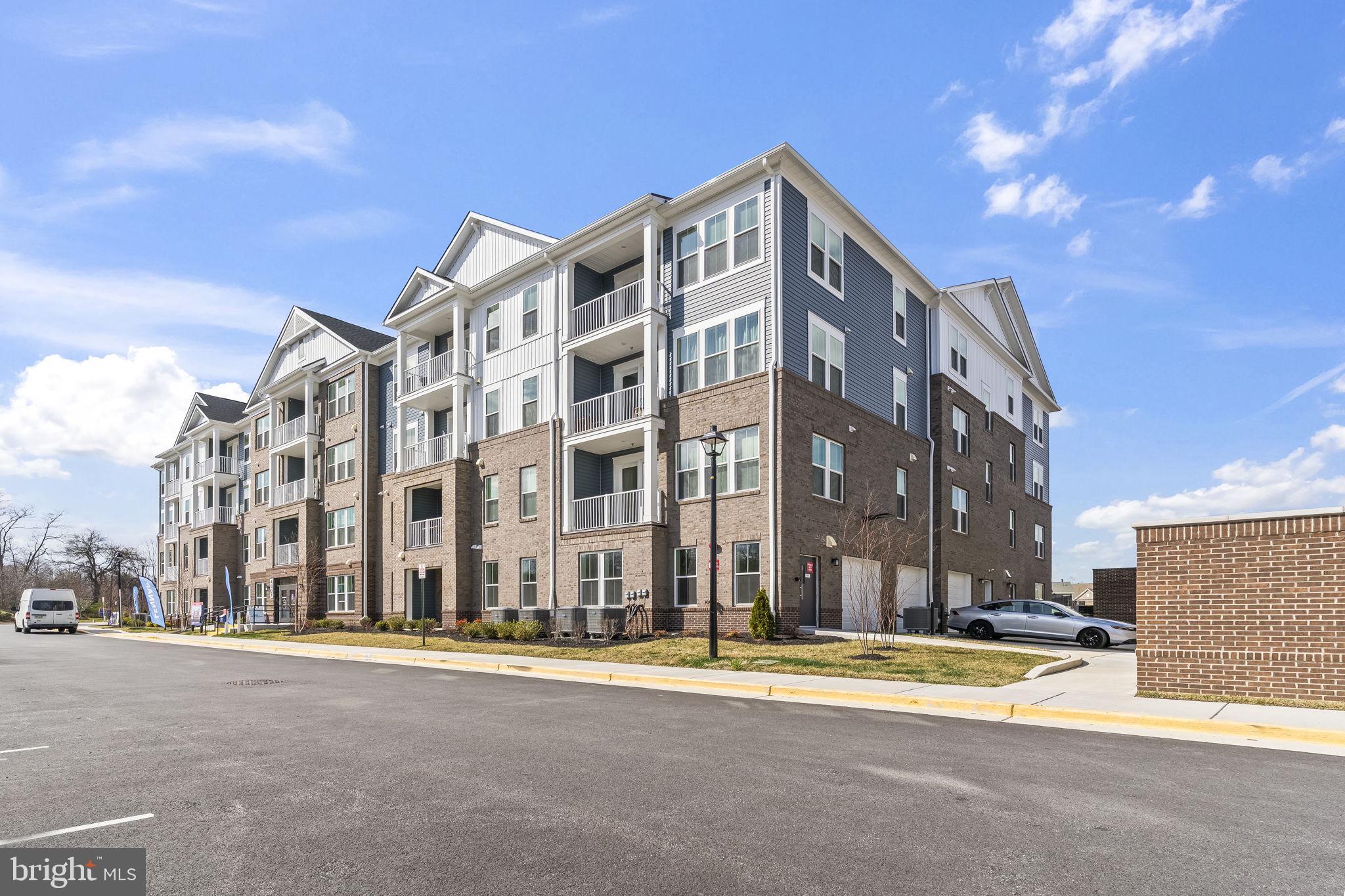 4007 Seaside Alder Road, Unit 8307 Bowie, MD 20720 - Photo 30 of 32 a view of a tall building next to a road