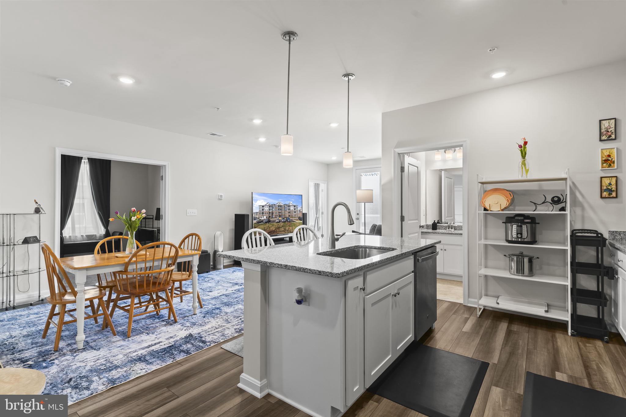 4007 Seaside Alder Road, Unit 8307 Bowie, MD 20720 - Photo 4 of 32 a kitchen with stainless steel appliances granite countertop a stove and a wooden floors