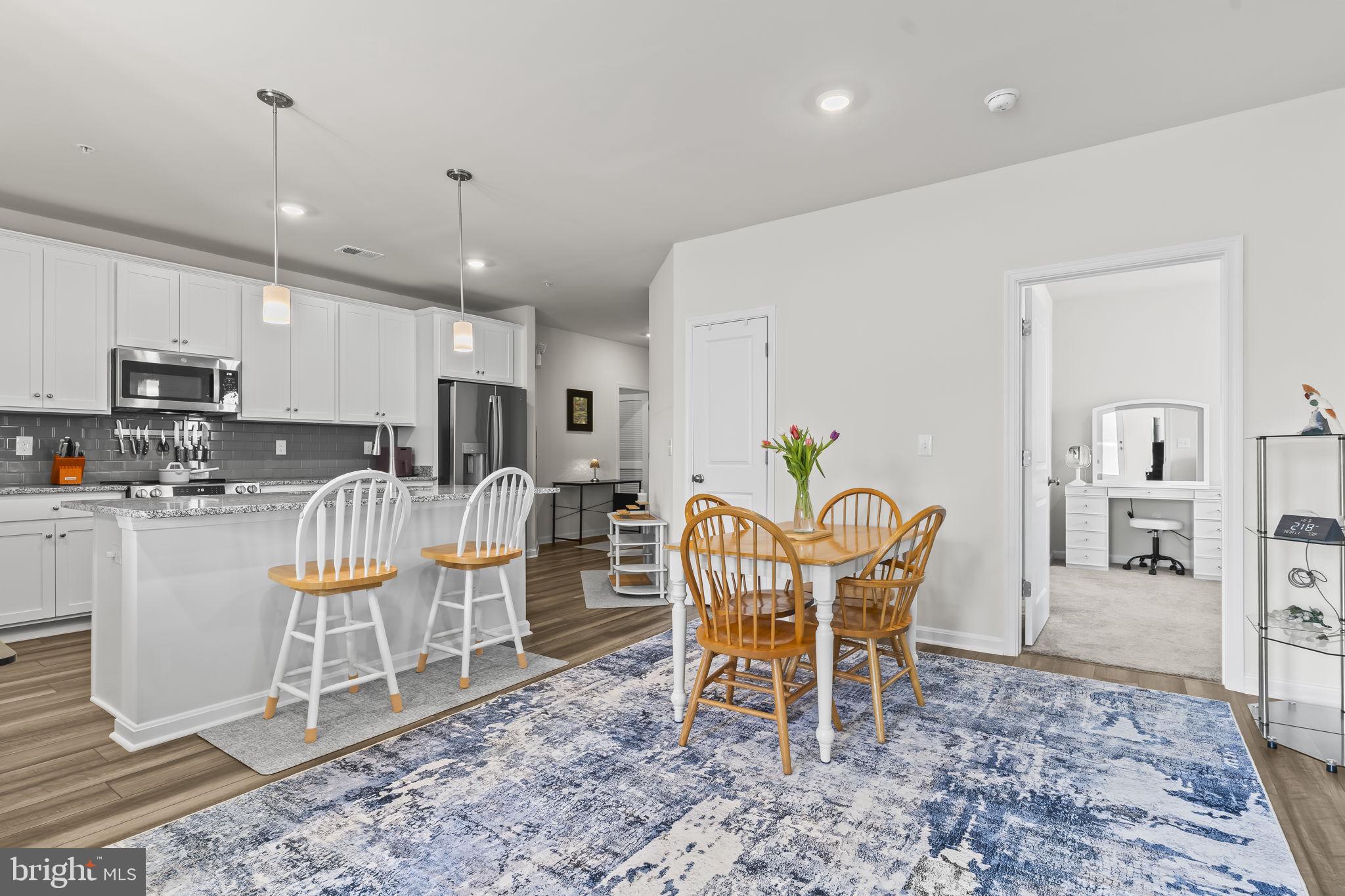 4007 Seaside Alder Road, Unit 8307 Bowie, MD 20720 - Photo 8 of 32 a dining room filled counter top space a center island and appliances