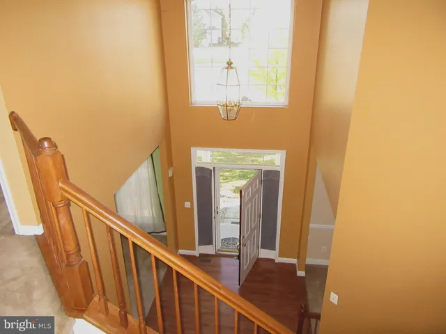 a living room with a fireplace furniture a fireplace and a chandelier