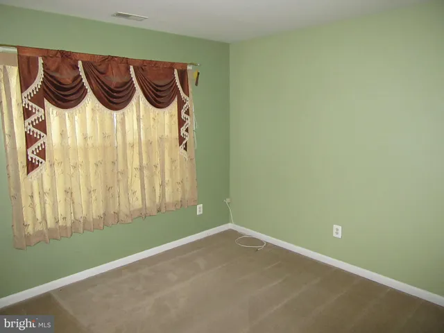 a bathroom view of a toilet and a shower