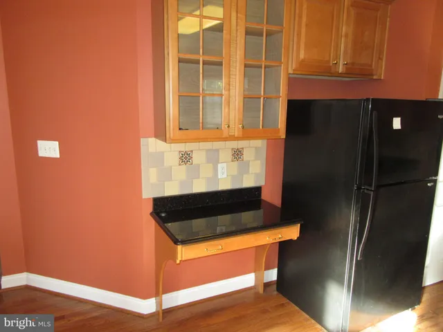a view of a livingroom with a fireplace and wooden floor