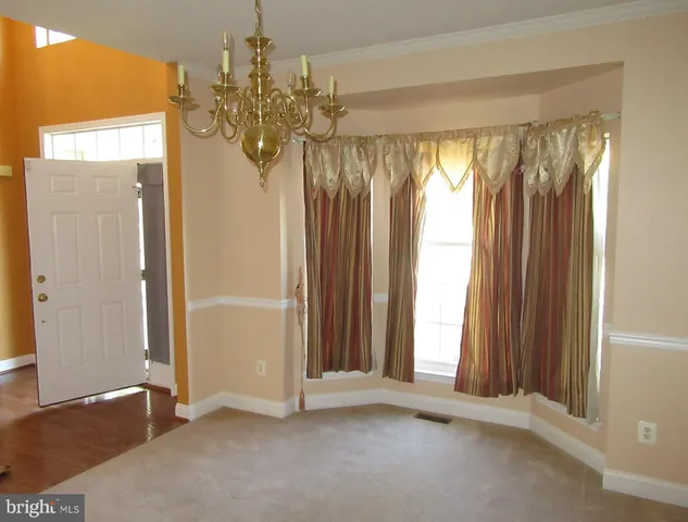 a view of room with window and wooden floor