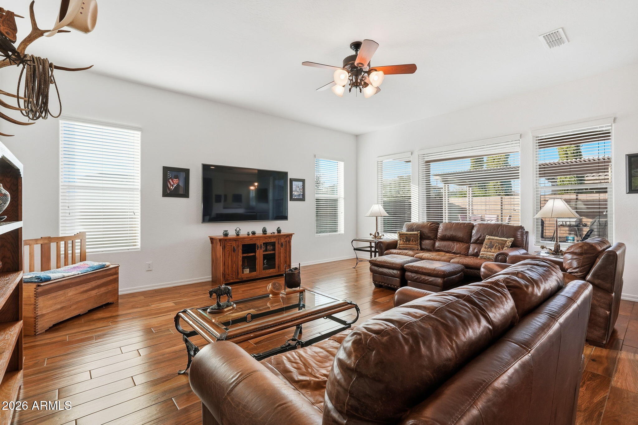 20066 East Russet Road Queen Creek, AZ 85142 - Photo 13 of 59 a living room with furniture a ceiling fan and a flat screen tv