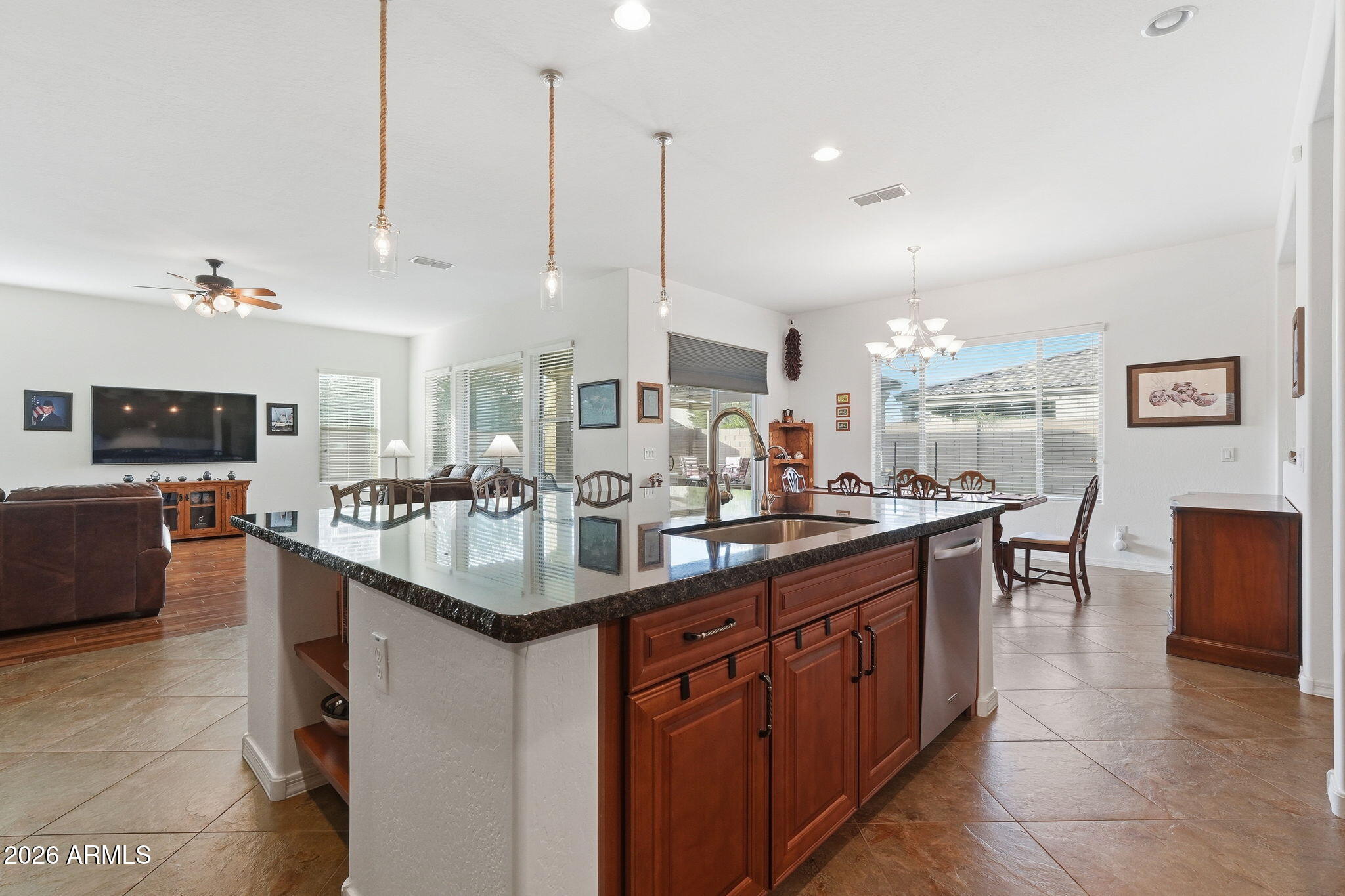 20066 East Russet Road Queen Creek, AZ 85142 - Photo 19 of 59 a kitchen with stainless steel appliances granite countertop a sink a counter top space and a living room view
