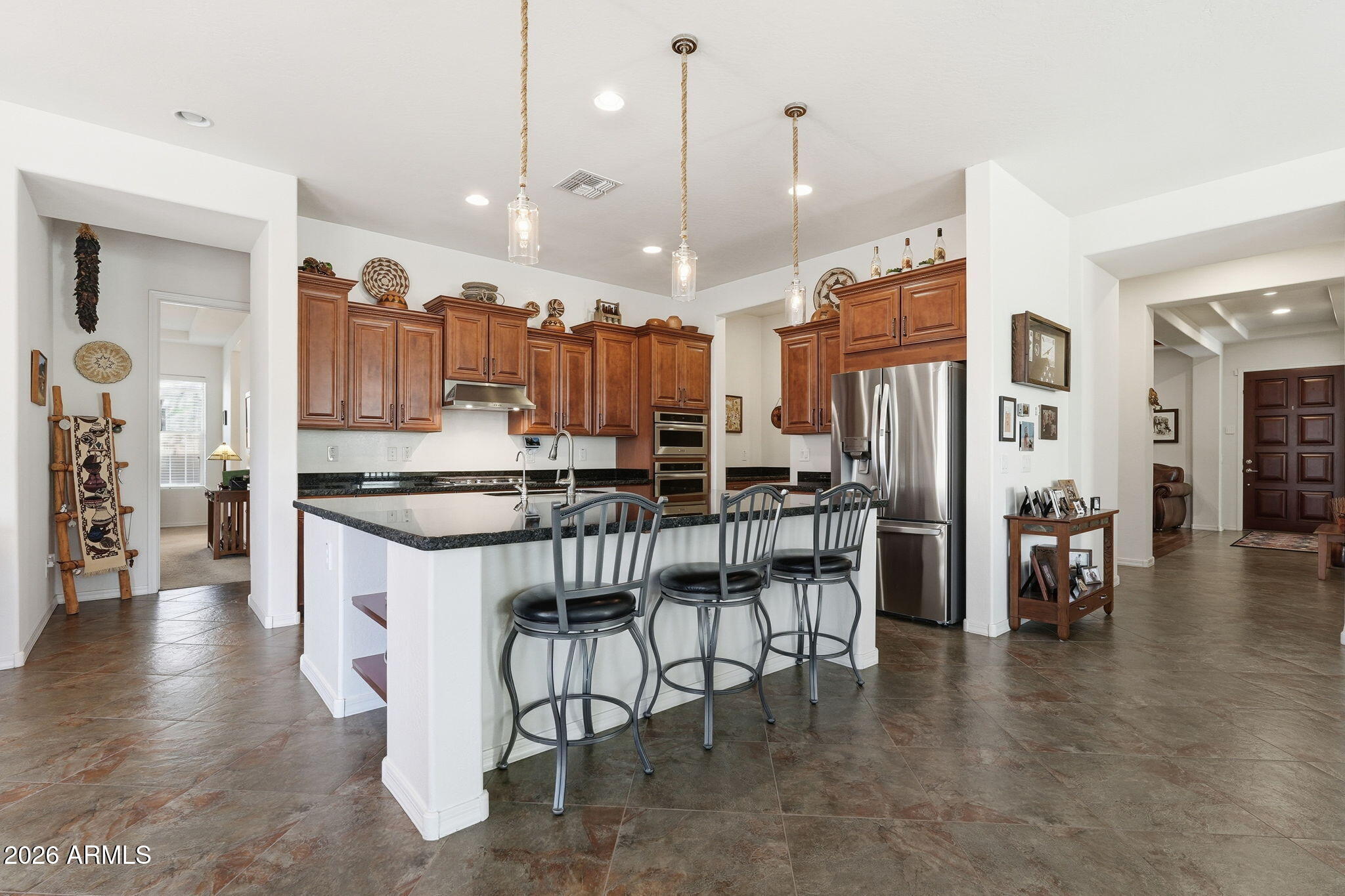 20066 East Russet Road Queen Creek, AZ 85142 - Photo 22 of 59 a kitchen with stainless steel appliances kitchen island granite countertop a stove a sink and a refrigerator