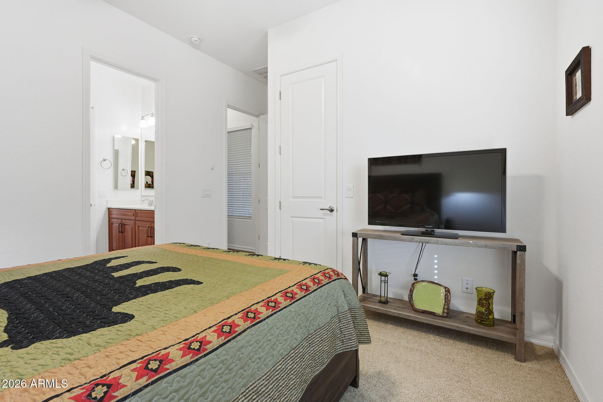 20066 East Russet Road Queen Creek, AZ 85142 - Photo 34 of 59 a bedroom with a bed and a flat screen tv