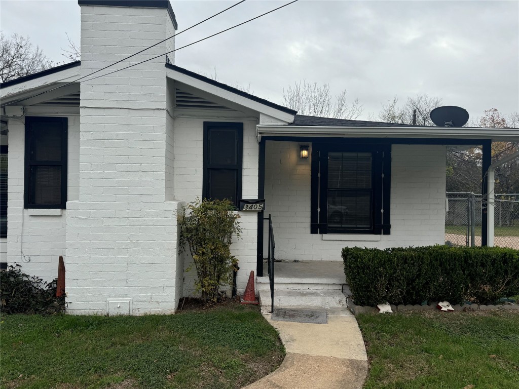 Entrance to property featuring brick siding