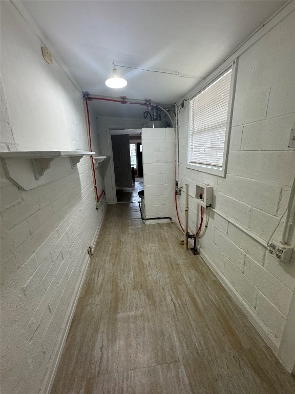 3405 Cherrywood Road Austin, TX 78722 - Photo 15 of 17 Basement featuring concrete block wall and light wood-style flooring