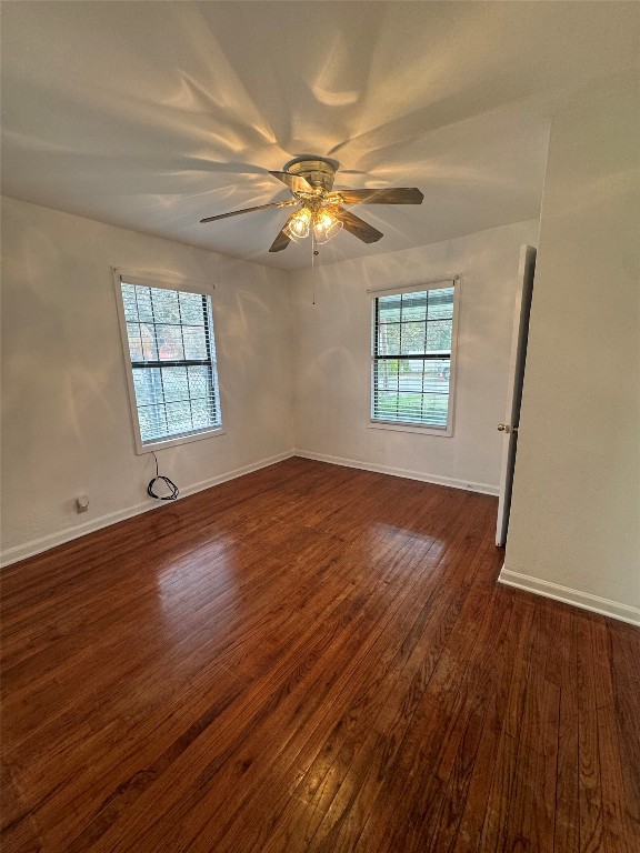3405 Cherrywood Road Austin, TX 78722 - Photo 6 of 17 Spare room featuring dark wood-type flooring and a ceiling fan