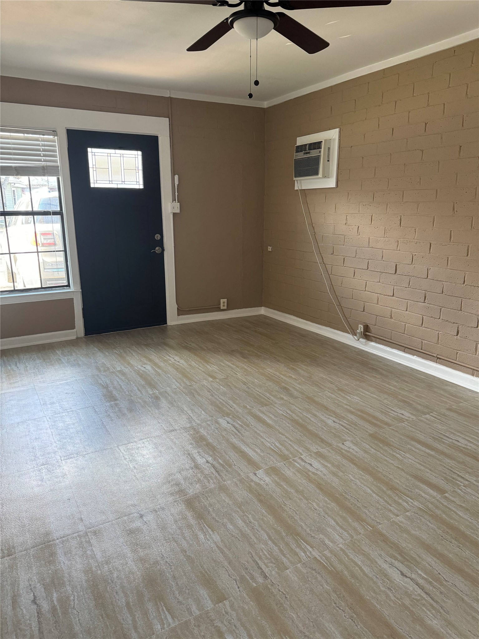 3405 Cherrywood Road Austin, TX 78722 - Photo 8 of 17 an empty room with wooden floor and windows