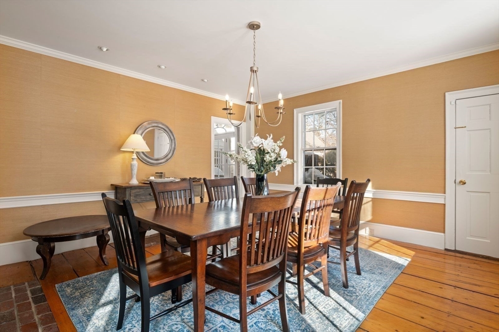45 School Street Manchester, MA 01944 - Photo 19 of 42 a dining room with furniture a chandelier and wooden floor
