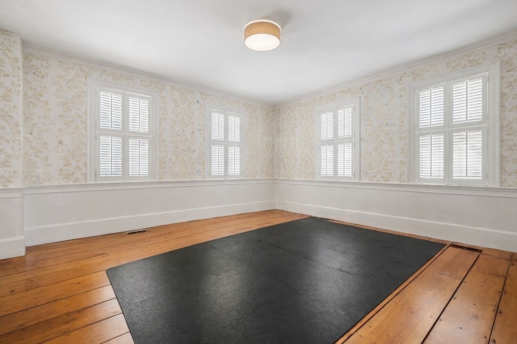45 School Street Manchester, MA 01944 - Photo 23 of 42 an empty room with wooden floor and windows
