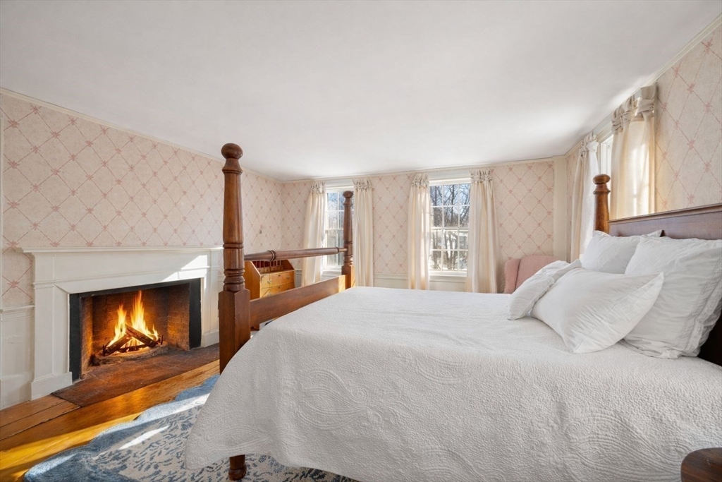 45 School Street Manchester, MA 01944 - Photo 26 of 42 a bedroom with a bed and a fireplace