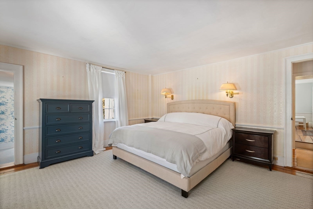 45 School Street Manchester, MA 01944 - Photo 31 of 42 a bedroom with a bed and a dresser