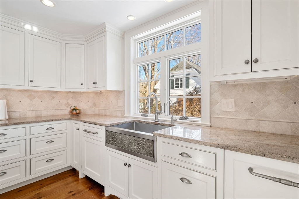 45 School Street Manchester, MA 01944 - Photo 5 of 42 a kitchen with granite countertop white cabinets and white appliances