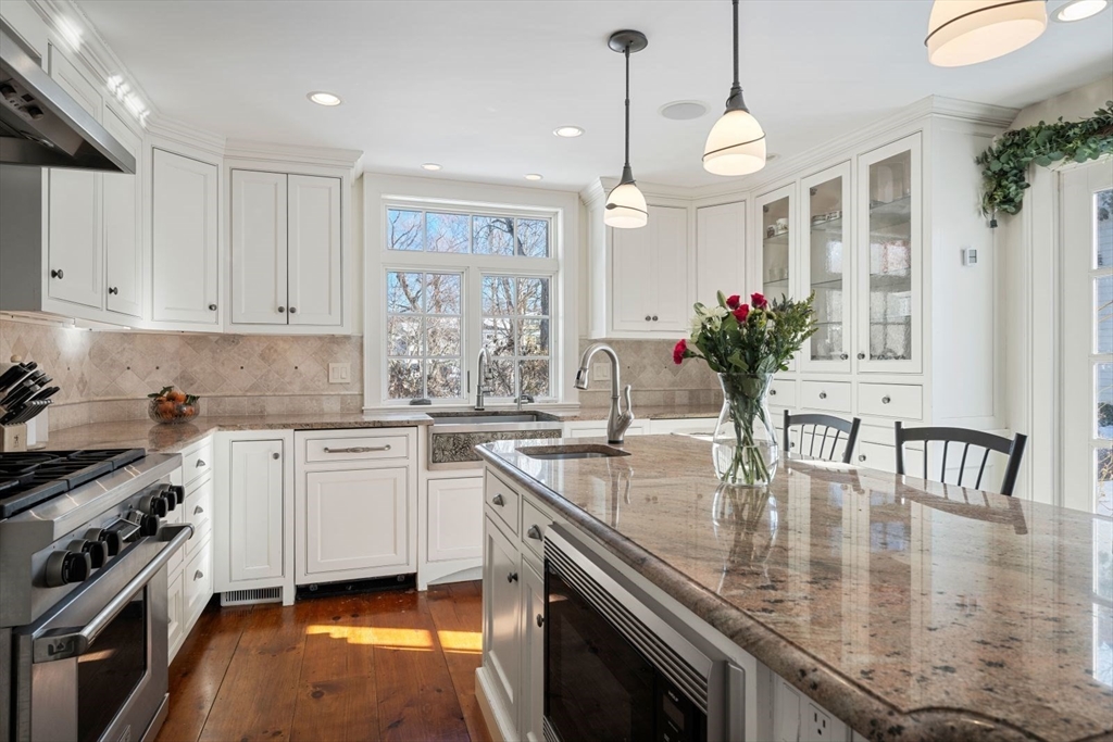 45 School Street Manchester, MA 01944 - Photo 8 of 42 a kitchen with stainless steel appliances granite countertop a sink a stove and cabinets