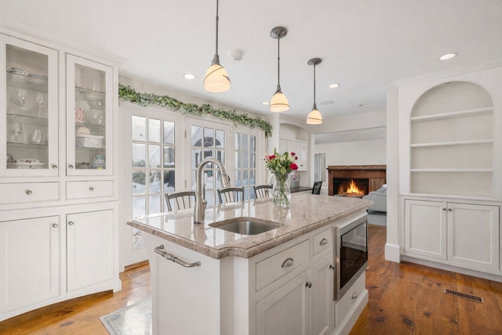 45 School Street Manchester, MA 01944 - Photo 9 of 42 a kitchen with white cabinets and sink