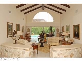 4356 Crayton Road Naples, FL 34103 - Photo 2 of 8 a living room with furniture and a large window