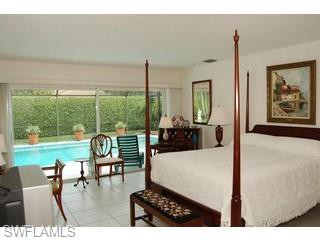 4356 Crayton Road Naples, FL 34103 - Photo 7 of 8 a living room with furniture and floor to ceiling windows
