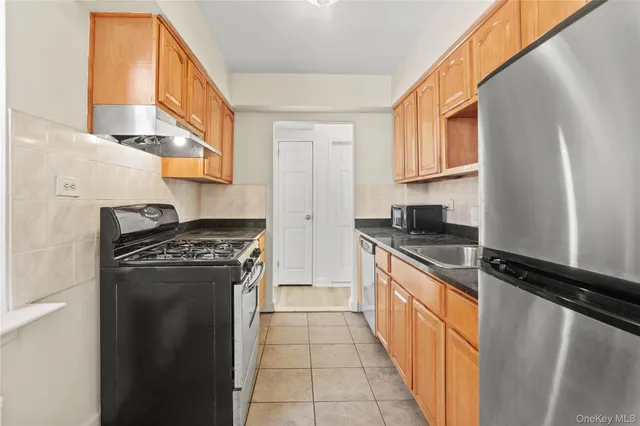 a kitchen with stainless steel appliances granite countertop a stove and a refrigerator