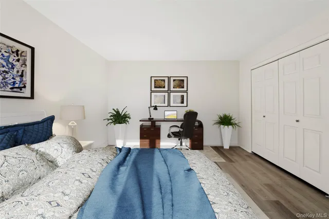 a bed room with a bed and a potted plant