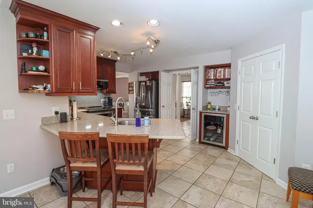 a kitchen with stainless steel appliances granite countertop a refrigerator and a sink