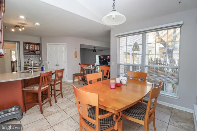 a view of a dining room with furniture a chandelier and wooden floor