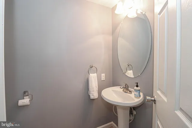 a bedroom with bed and a flat tv screen on dresser