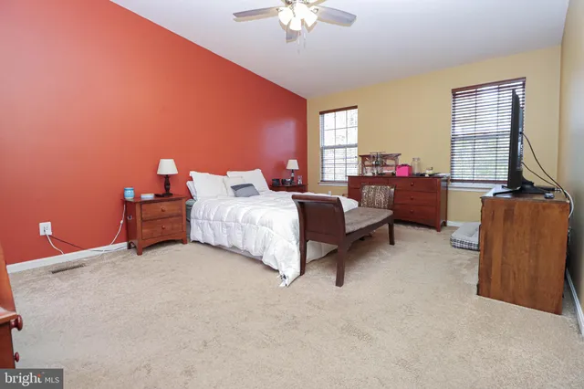 a spacious bathroom with a tub sink and mirror