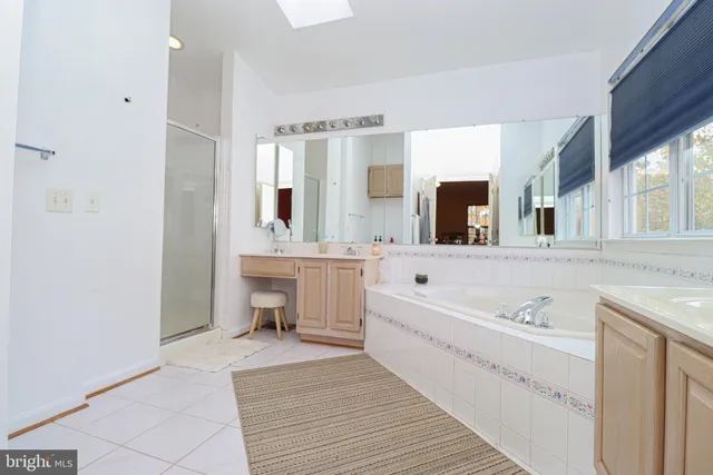 a bedroom with a bed a desk and chair with the wooden floor