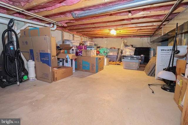 a dining room with wooden floor and a chandelier