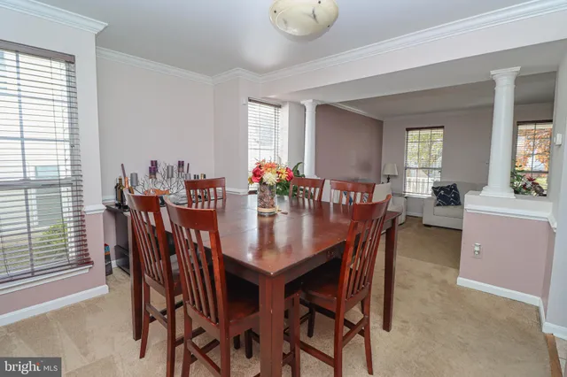 a view of a dining room with furniture and a potted plant
