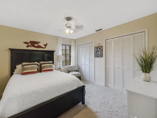 a bedroom with a bed and a potted plant