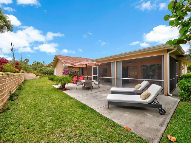 a view of a patio with couches table and chairs with garden view