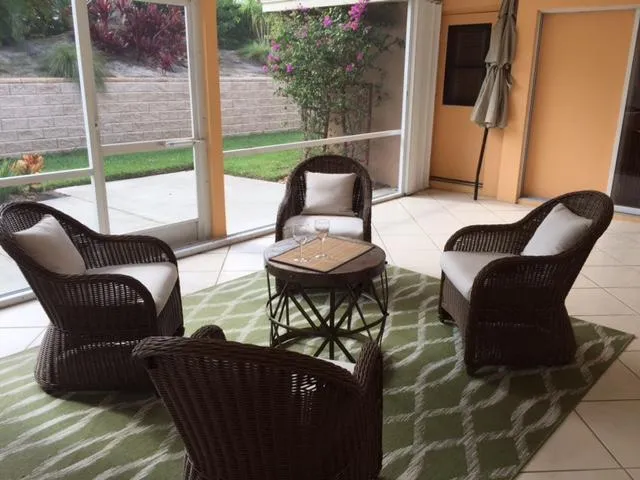 a balcony with table and chairs