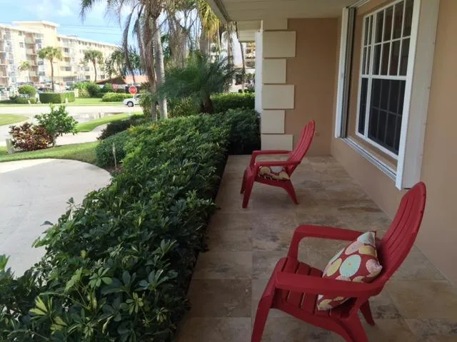 a view of a patio with table and chairs and potted plants