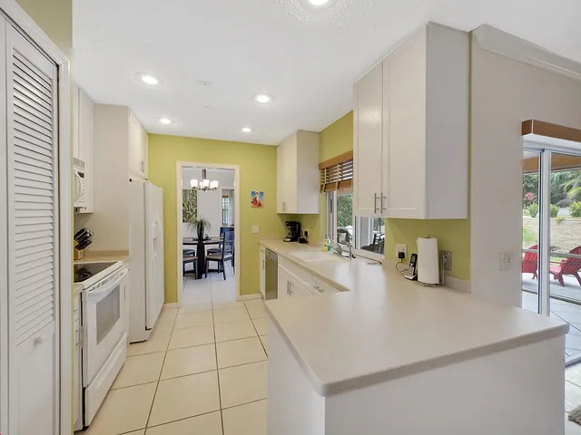 a kitchen with stainless steel appliances a sink a stove a refrigerator and cabinets