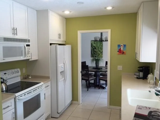 a kitchen with refrigerator and cabinets