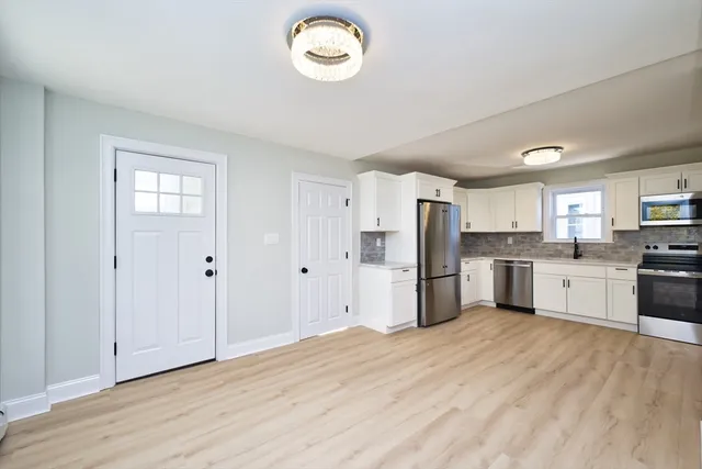 a kitchen with stainless steel appliances a refrigerator and a sink