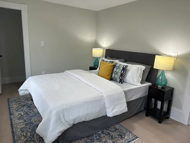 a bedroom with a bed and chair