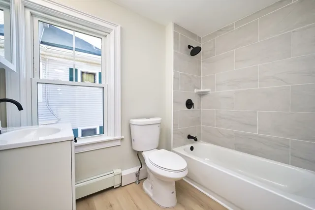 a bathroom with a toilet a sink and bathtub