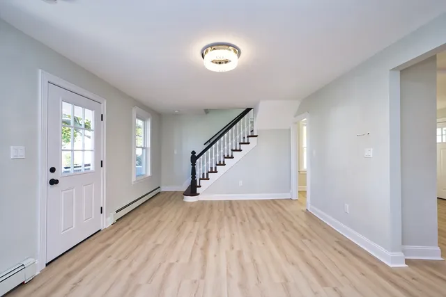 a view of an entryway with wooden floor