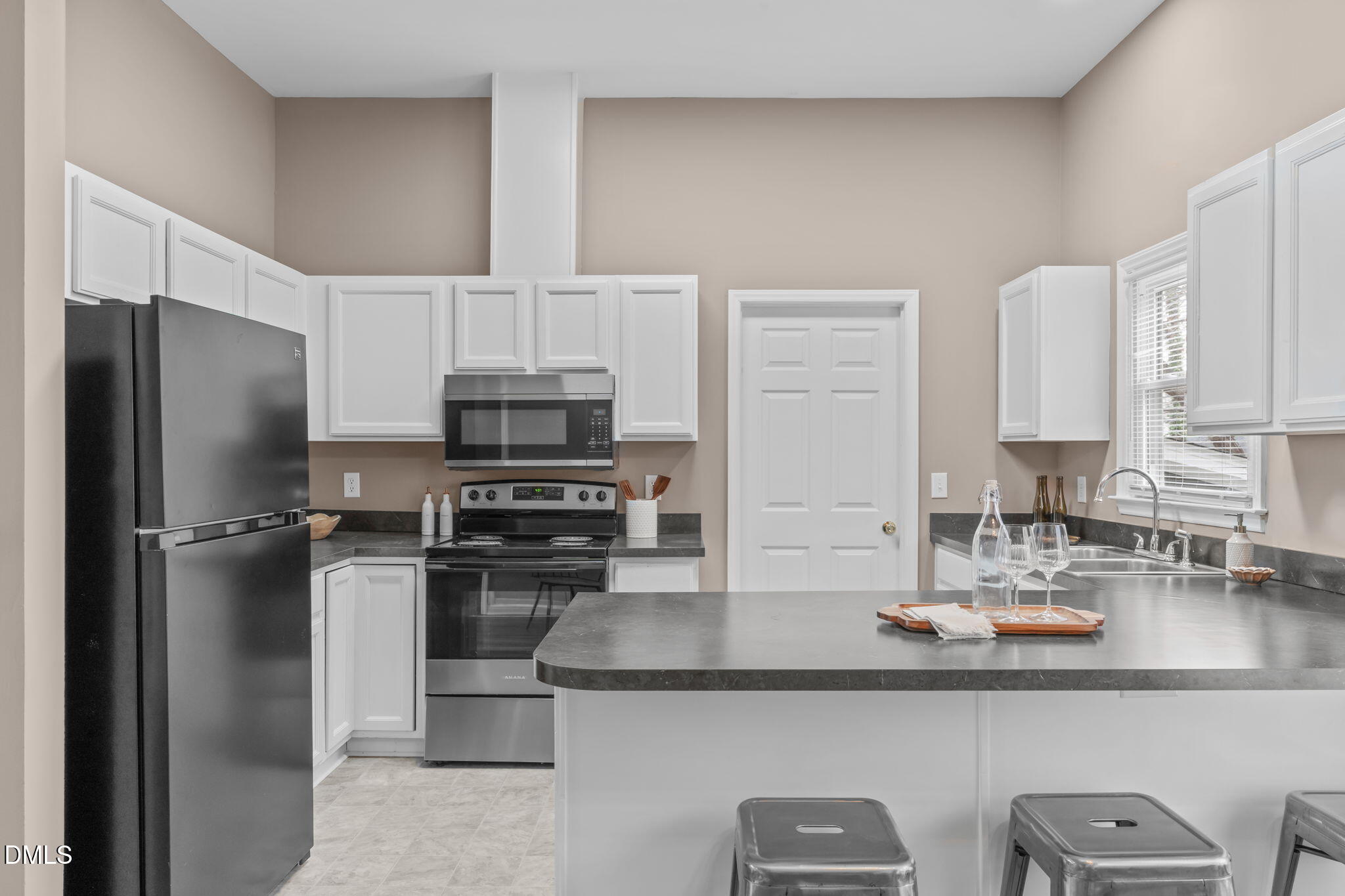 420 Johnson Street Garner, NC 27529 - Photo 15 of 43 a kitchen with stainless steel appliances a sink stove refrigerator and cabinets