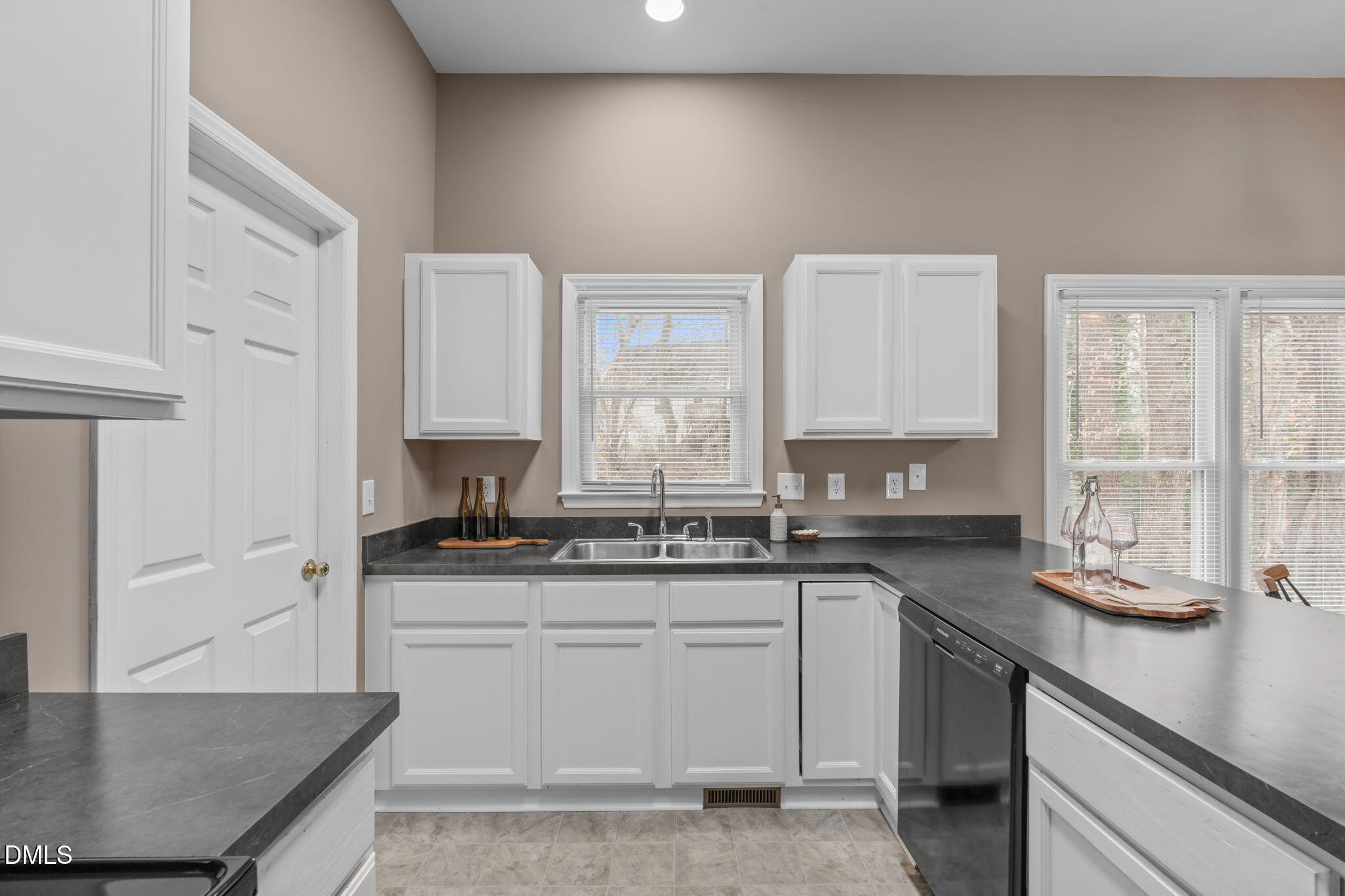 420 Johnson Street Garner, NC 27529 - Photo 17 of 43 a kitchen with granite countertop a sink a stove and cabinets