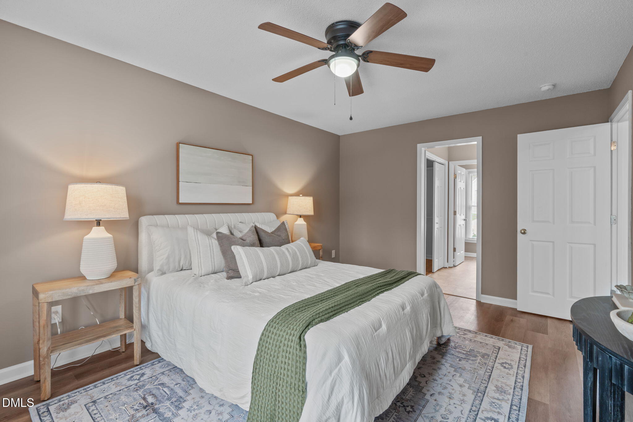 420 Johnson Street Garner, NC 27529 - Photo 22 of 43 a bedroom with a bed and a lamp on a dresser