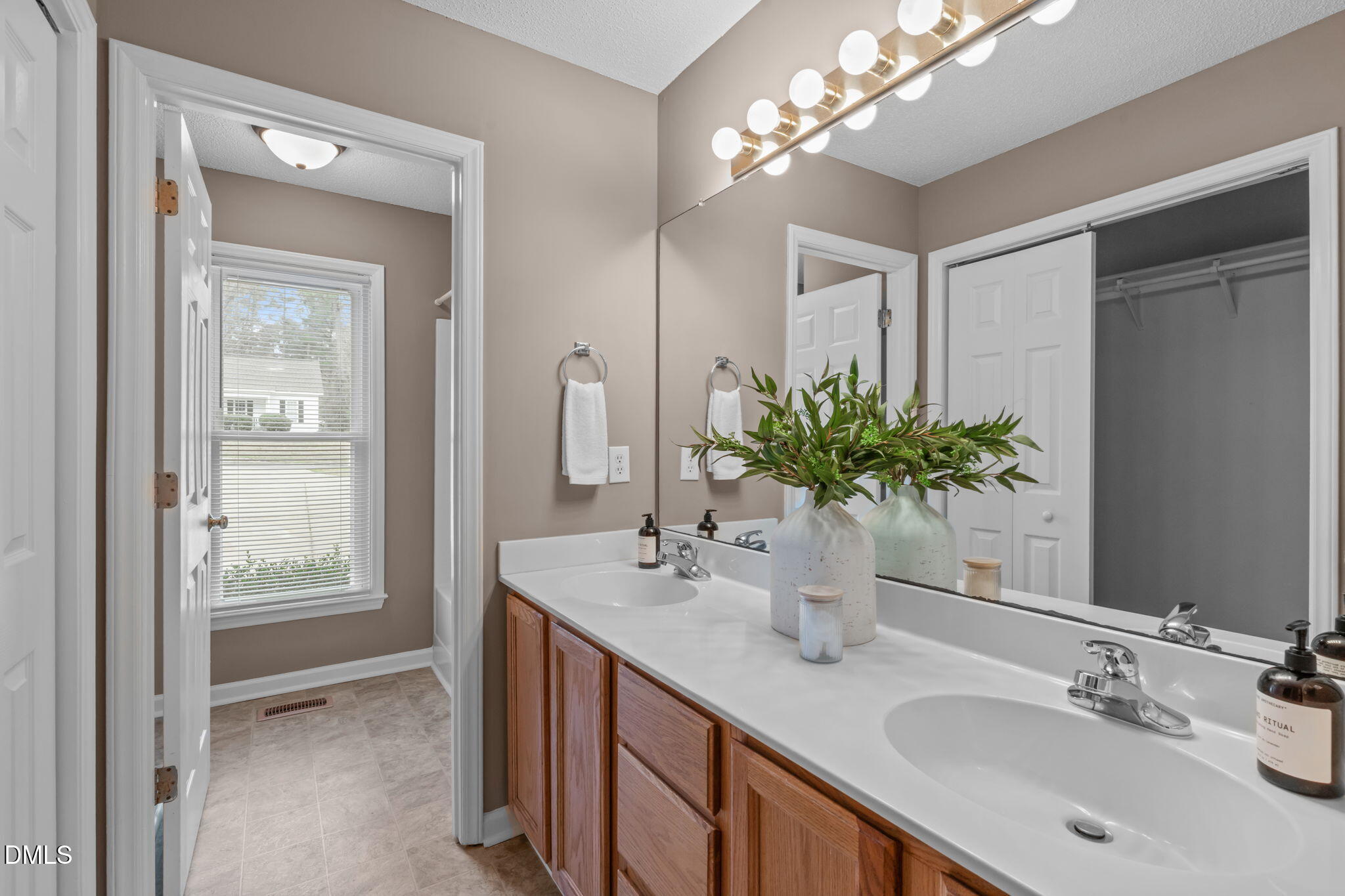 420 Johnson Street Garner, NC 27529 - Photo 25 of 43 a bathroom with a double vanity sink and a mirror
