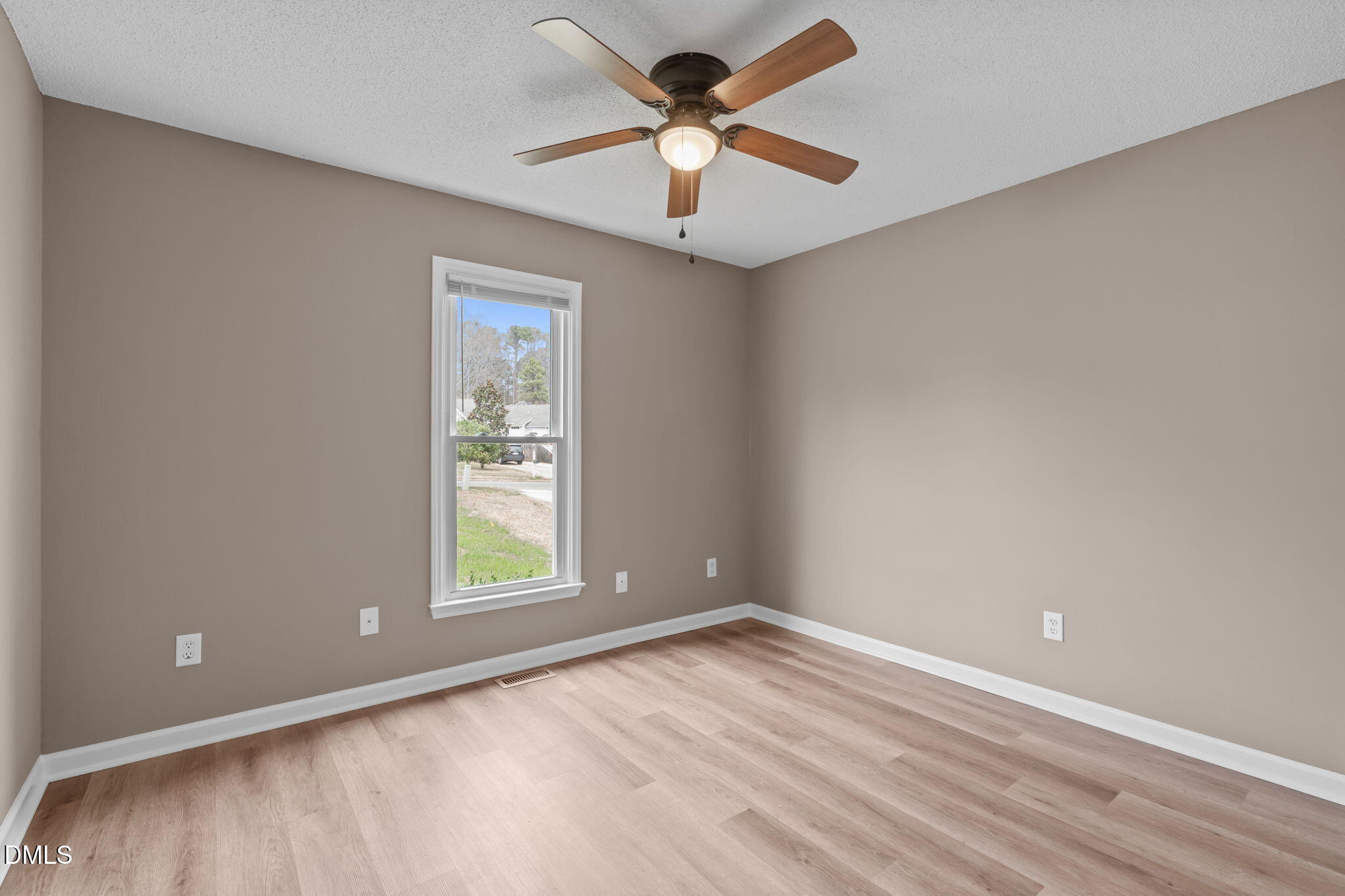 420 Johnson Street Garner, NC 27529 - Photo 28 of 43 an empty room with a window and a fan