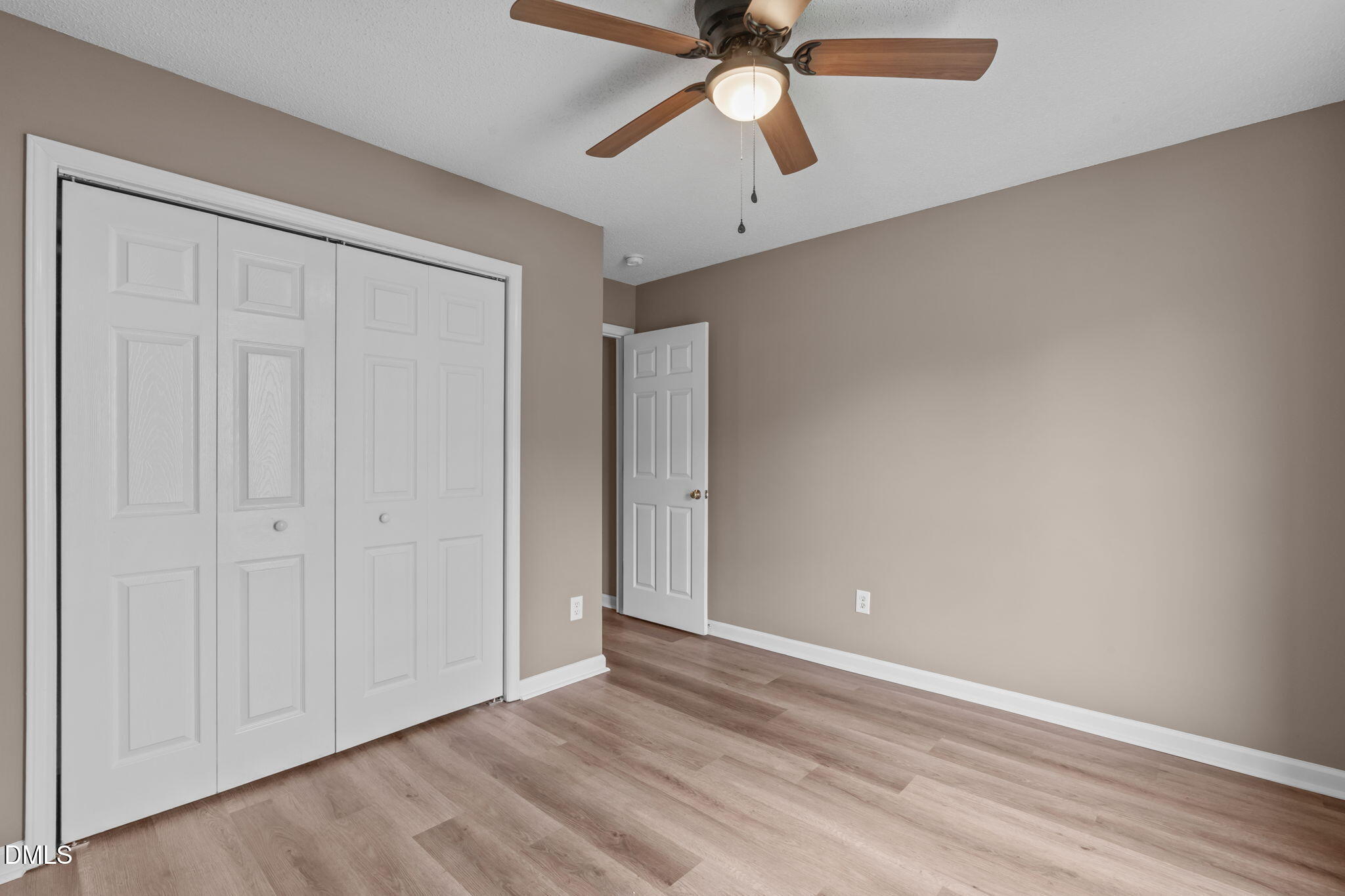 420 Johnson Street Garner, NC 27529 - Photo 29 of 43 an empty room with a ceiling fan and wooden floor
